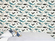 Ocean wallpaper with whales behind a bed and velveteen rabbit