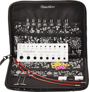 Open case showing steel needle tips, white gauge, red cables, white stoppers