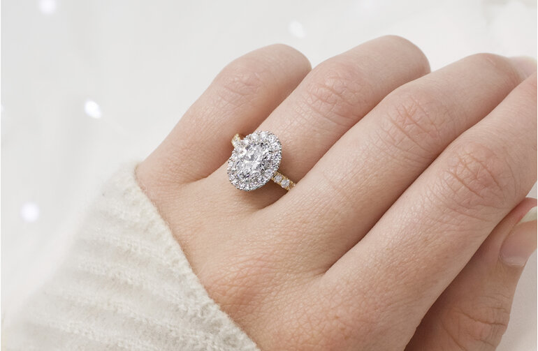Oval diamond halo engagement ring with diamond band 18ct yellow gold platinum
