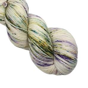 part skein of yarn in cream, lilac, green with hints of blue and pink