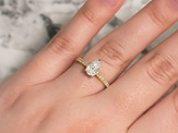 Pear cut solitaire with diamond set band, platinum and 18ct yellow gold, on hand