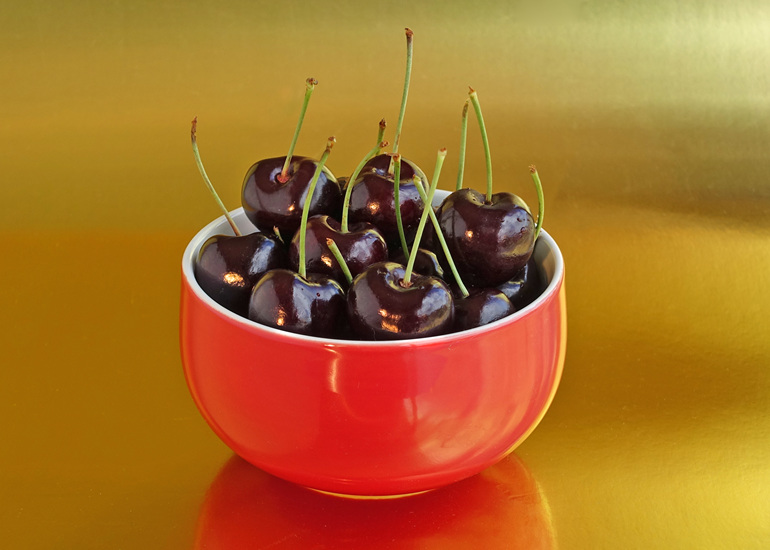 Red bowl of cherries