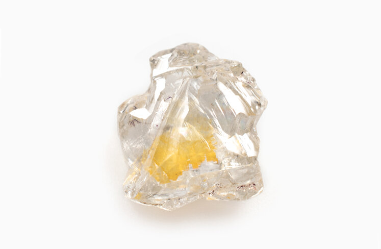rough diamond with trapped nitrogen causing a yellow inclusion in the centre
