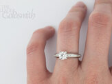 Round Brilliant Cut Diamond Ring with Shoulders on hand