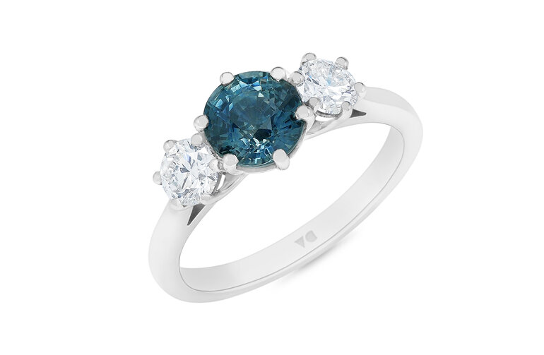 Round teal sapphire and diamond three stone ring crafted in platinum, engagement