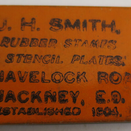 Rubber Stamp in a tin