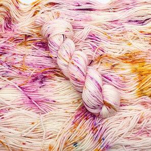 skein 100% DK merino on cream base with hot pink, gold speckles with blue pops