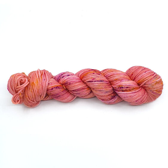 skein 100% DK merino peachy pink with speckles in yellow, hot pink with blue pop