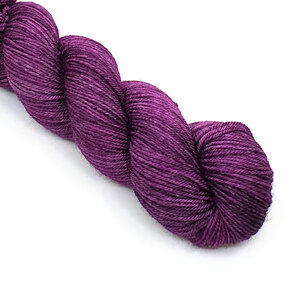 skein of 100% Bluefaced Leicester wool in a dark magenta semi solid colour