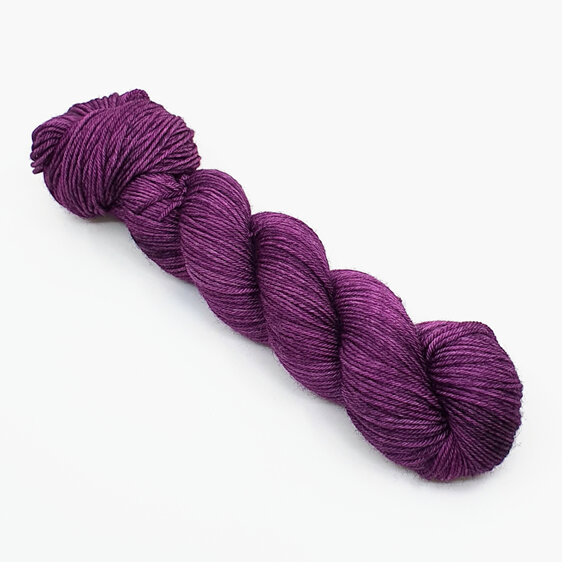 skein of 100% Bluefaced Leicester wool in a dark magenta semi solid colour