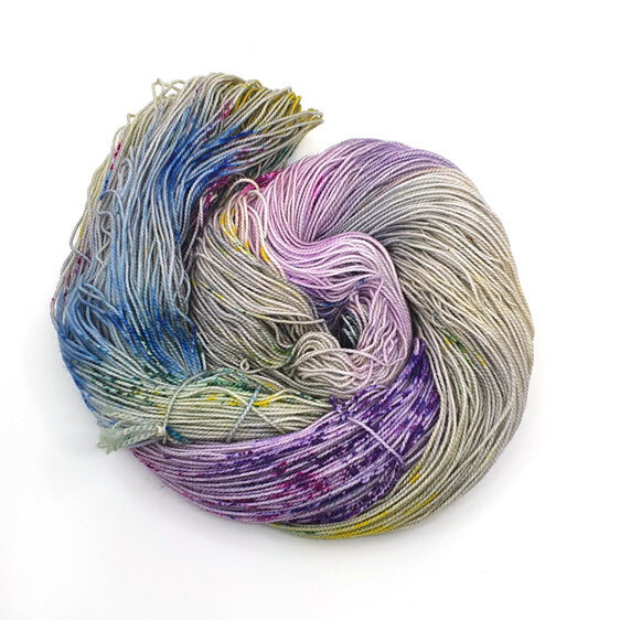 skein of 75/25 merino/nylon grey base with yellow blue green pink purple speckle