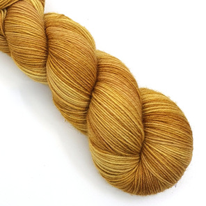 skein of 85/15 merino/nylon yarn in a semi-solid golden mustard colour