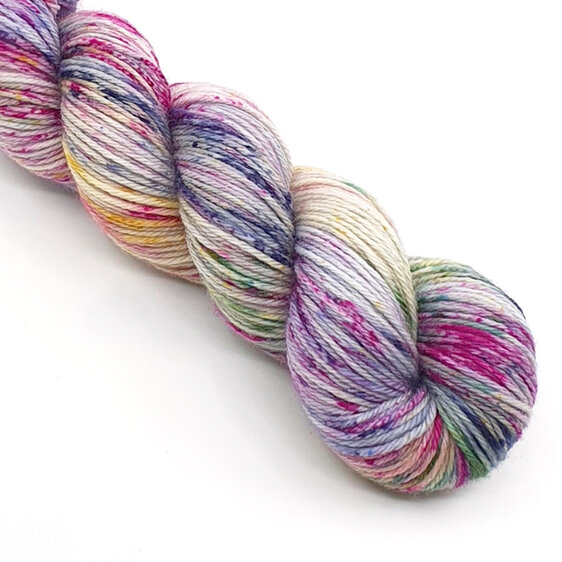 skein of variegated speckled yarn in blue, lilac, purple, green and yellow