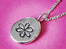 small fine silver nugget pendant with whimsical flower detail