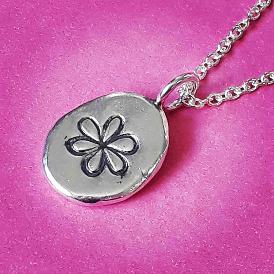small fine silver nugget pendant with whimsical flower detail