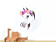Small horse decal with flower crown on white background with wooden animal toys