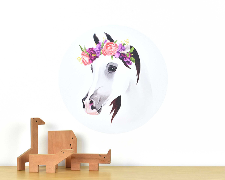Small horse decal with flower crown on white background with wooden animal toys