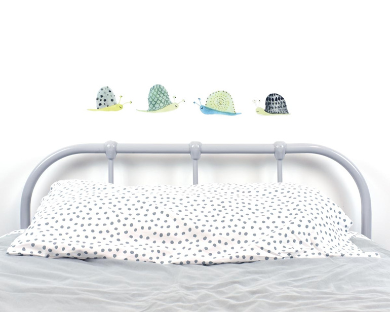 Snail wall decals in line with bed