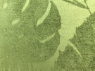 The green textured leaf fabric on the front pocket of the bag.