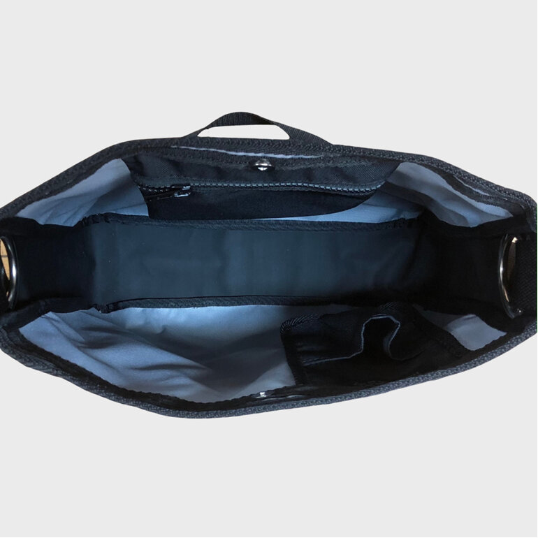 The interior of this carryall consists of a phone pocket and zip pocket