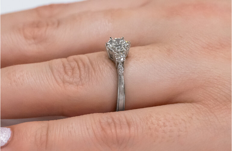 Three stone diamond engagement ring on hand celtic inspired design milgrain