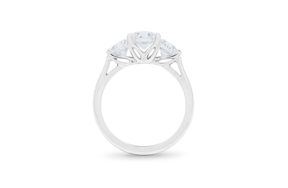 Three stone round brilliant cut diamond engagement ring platinum lotus setting