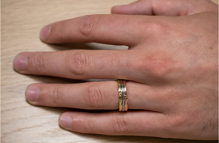 Tri-tone mens wedding ring with koru motif detailing yellow white and rose gold