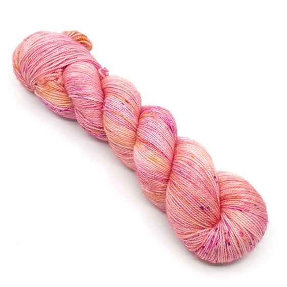 twisted skein 4ply variegated yarn in peach pink with hot pink and gold speckles
