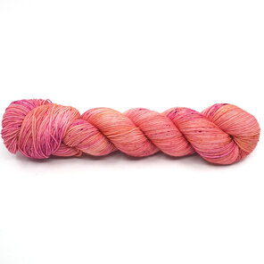 twisted skein of 4ply Bluefaced Leicester in peachy pink with speckles