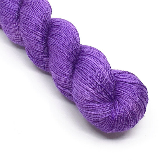 twisted skein of 4ply merino silk yarn in purple hues