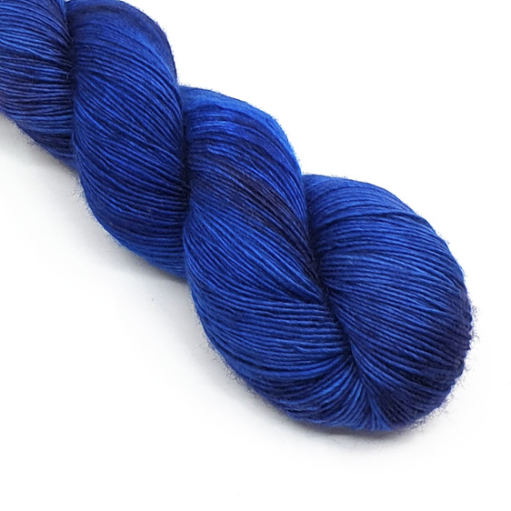 twisted skein of 4ply variegated merino yarn in sapphire blue and lilac hues