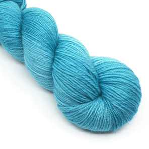 twisted skein of 4ply wool in teal hues