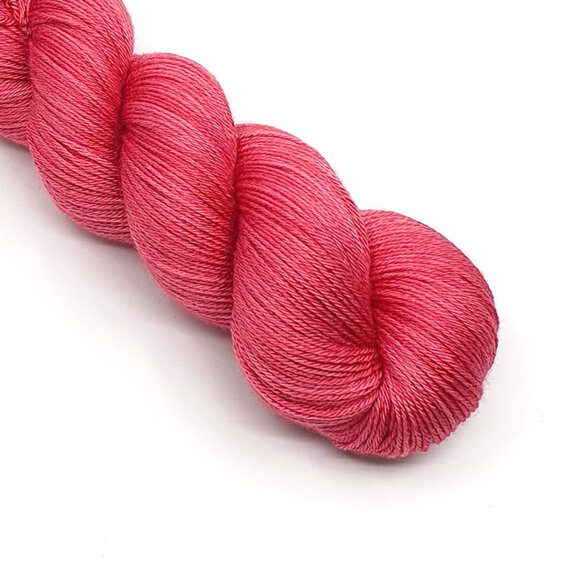 twisted skein of 4ply yarn in a pinky red