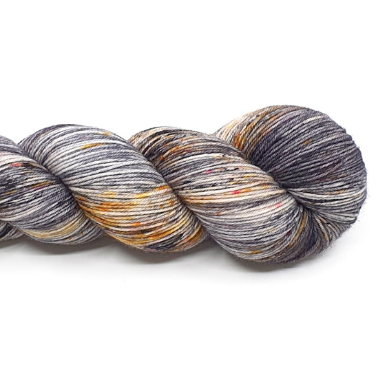 twisted skein of 85/15 merino/nylon in grey, gold & black with speckles