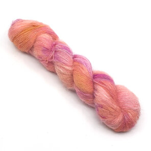 twisted skein of brushed suri alpaca and silk in peaches pinks and golden yellow