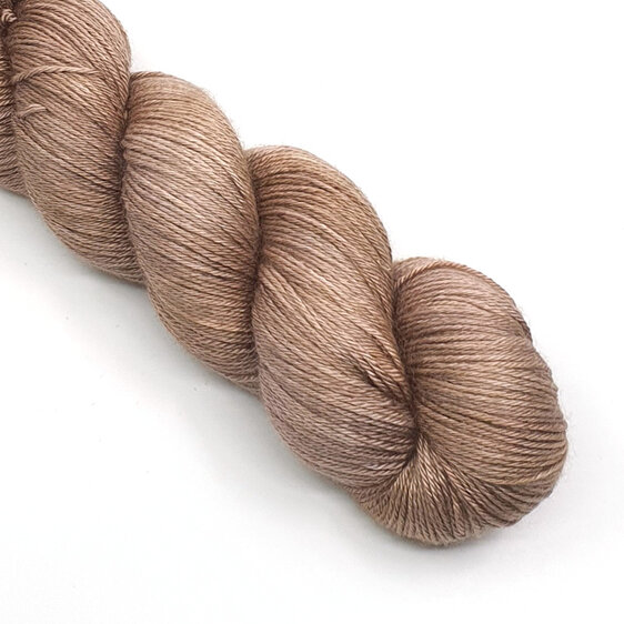 twisted skein of merino silk yarn in a light caramel brown tone
