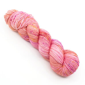 twisted skein of yarn apricot/peach with hot pink, gold and blue speckles