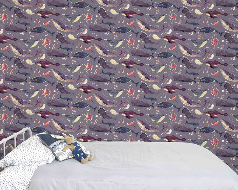 Whale wallpaper with lavender background behind bed and velveteen rabbit