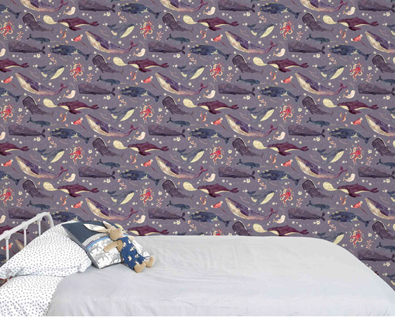 Whale wallpaper with lavender background behind bed and velveteen rabbit